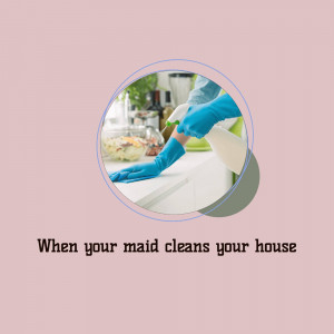 Person in blue gloves cleaning a kitchen counter with spray and cloth