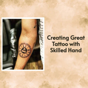 Close-up of a compass tattoo being worked on by a tattoo artist.