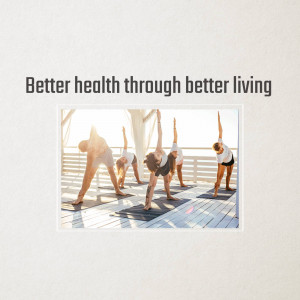 Group of people practicing yoga outdoors on a wooden deck with a sunset background.