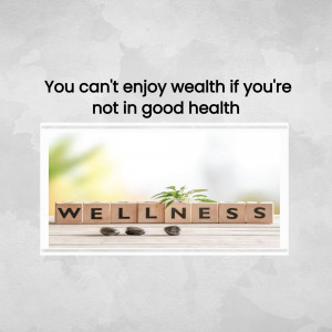 Wooden blocks spelling 'WELLNESS' with a blurred background of a person relaxing.