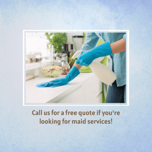 Person wearing blue gloves cleaning a kitchen counter with spray bottle