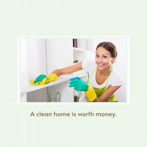 Woman cleaning white kitchen cabinets with a smile