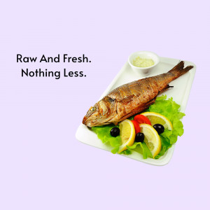 Grilled fish served with lemon, olives, and a side of sauce on a white plate.