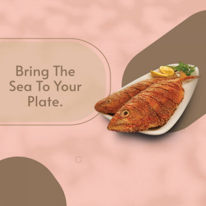 Two fried fish served on a white plate with lemon and greens