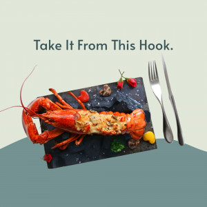 A beautifully presented cooked lobster on a slate plate with silverware and garnish.