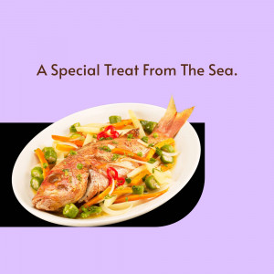 A close-up of a whole fried fish served with colorful vegetables on a white plate.