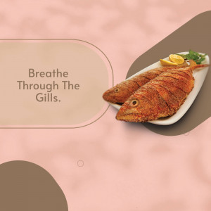 Two pieces of golden-brown fried fish served with lemon and greens on a white plate.