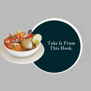 A bowl of spicy seafood soup with crab, clams, and chili peppers.