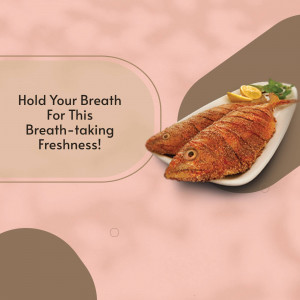 Close-up of two golden-brown fried fish fillets on a white plate with lemon and greens.