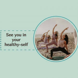 Group of people practicing yoga on a beach at sunset.