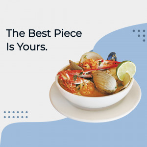 A bowl of vibrant Tom Yum soup with shrimp, crab, mussels, and lime.