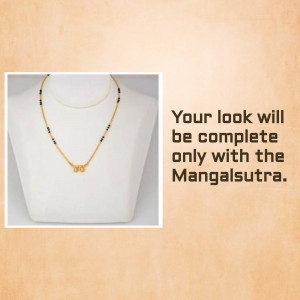 Close-up of a delicate gold mangalsutra necklace on a white mannequin.