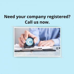 Hand stamping a copyright symbol on documents, representing company registration.