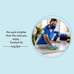 Woman cleaning a kitchen counter with spray and cloth, wearing a mask.