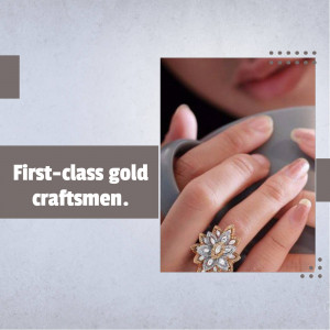 Close-up of a hand wearing a detailed gold ring with gemstones.