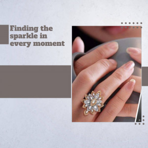 Close-up of a hand wearing a gold ring with a sparkling gemstone.