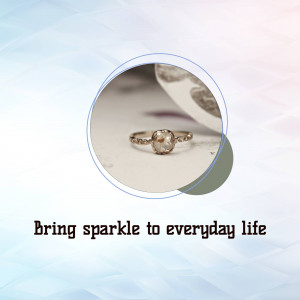 Close-up of a delicate gold ring with a light brown gemstone.