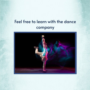 A dancer performing a handstand on a stage with colorful lighting.