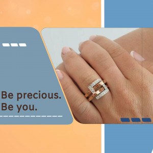 Close-up of a hand wearing two gold and diamond rings with the text 'Be precious. Be you.'
