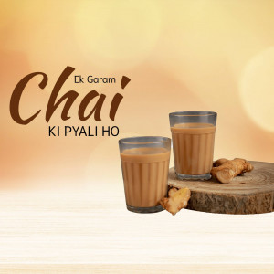 A glass of chai with ginger on a wooden surface
