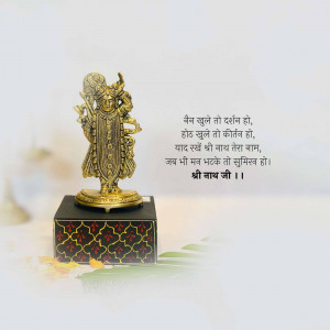 Golden Krishna idol on a black pedestal with Hindi text in the background