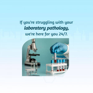 A gloved hand holding a blood sample near a microscope and other lab equipment.
