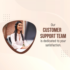 Customer support representative wearing a headset and smiling while working on a computer.
