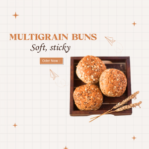 Close-up of three multigrain buns in a wooden tray with wheat stalks