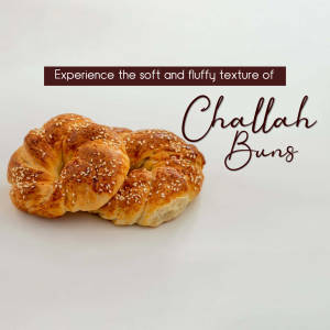 Close-up of golden brown challah buns with sesame seeds