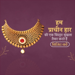 Close-up of a gold necklace with intricate detailing and a red gemstone.