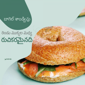 A close-up shot of a bagel sandwich filled with salmon, cream cheese, and greens.