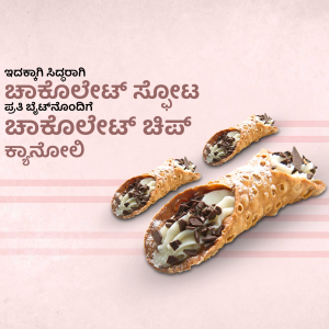 Three cannoli pastries filled with creamy white filling and chocolate chips on a pink striped background.