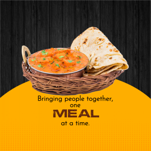 A basket of butter chicken with naan bread on a wooden surface with a yellow background.