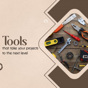 A collection of various hand tools arranged on a wooden surface.