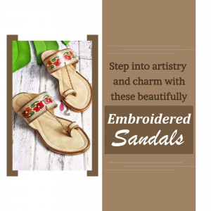 Pair of beige embroidered sandals with floral details on a brown background.