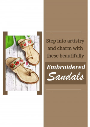 Pair of beige embroidered sandals with floral details on a textured surface.