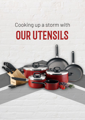 A collection of red and silver cookware including pots, pans, and knives on a grey surface.