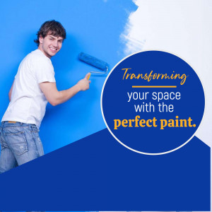 Man painting a blue wall with a paint roller