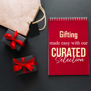 Flat lay of a shopping bag, gift boxes, and a notebook with 'Gifting made easy' text.