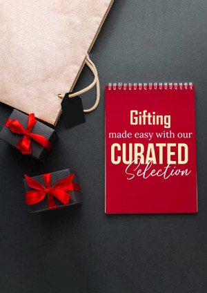 Flat lay of gifting items including a notebook, gift boxes, and a shopping bag.