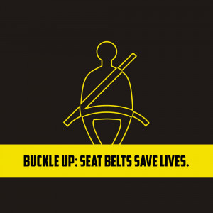 Yellow line art illustration of a person in a car wearing a seatbelt with the text 'Buckle Up: Seat Belts Save Lives.'
