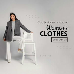 Woman in stylish blazer and pants posing next to a chair, promoting women's clothes.