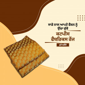 Close-up of folded golden Punjabi fabric with decorative patterns.