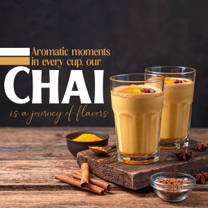 Two glasses of chai tea with spices on a wooden surface