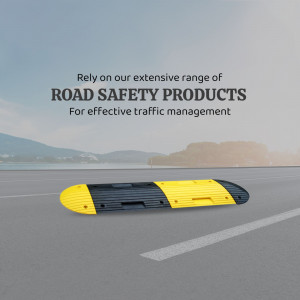 Yellow and black speed bump on a road with blurred background