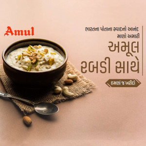 A bowl of Amul Rabdi with nuts and a spoon