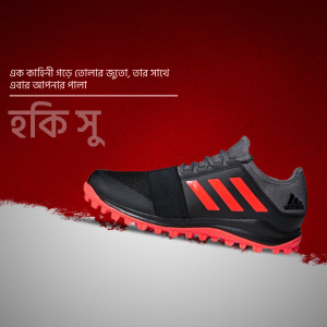 Close-up of black and red Adidas running shoes with a textured sole on a red and white background.