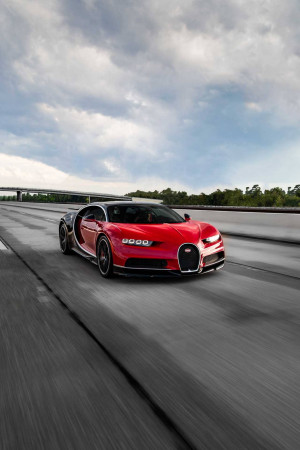 Red and black Bugatti Chiron Super Sport speeding on a highway