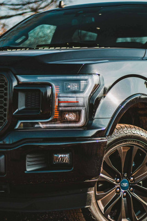 Close-up of a black Ford F-150 truck's front end