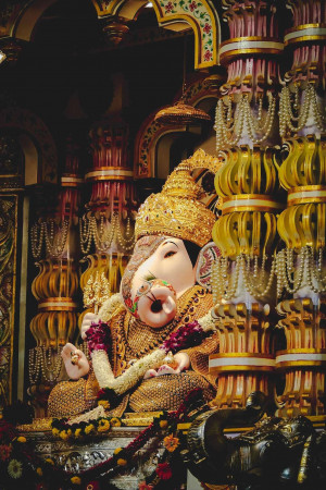 Close-up of a beautifully decorated Ganesha idol with intricate details and vibrant colors.